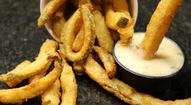 pickle fries and ranch dressing in a ramekin