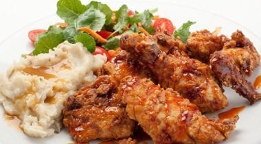 honey hot chicken wings with mashed potatoes and salad