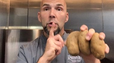 Chef Tim holding potatoes, shushing camera 