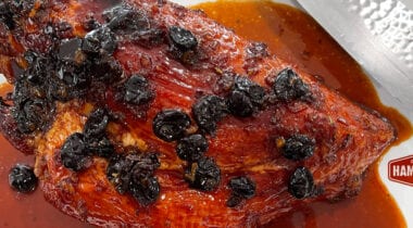 ham with red glaze sauce and dried cherries