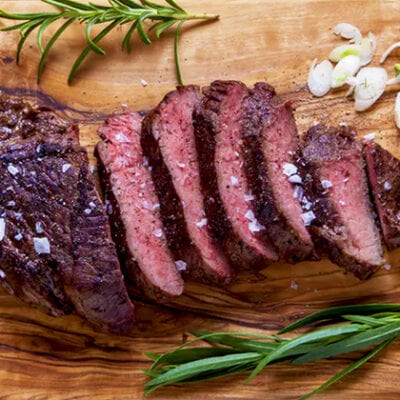 teres steak sliced on cutting board with seasonings