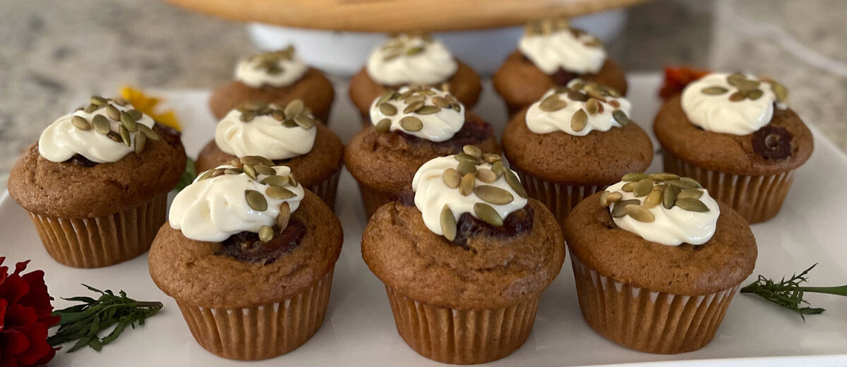 brown cupcakes with frosting and pumpkin seeds