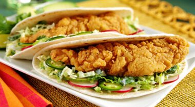 crestview breaded chicken fritters in soft taco shell on white plate