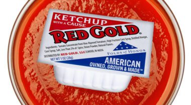 red gold ketchup cup over bowl of ketchup